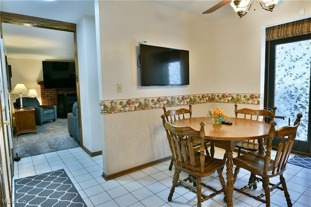 8518 Four Seasons Trl, Poland, OH 44514 - tiled dining space with ceiling fan, a fireplace, wainscoting, and carpet