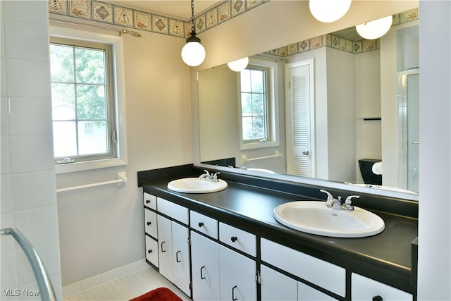 8518 Four Seasons Trl, Poland, OH 44514 - full bathroom with double vanity, a shower with door, and tile patterned floors