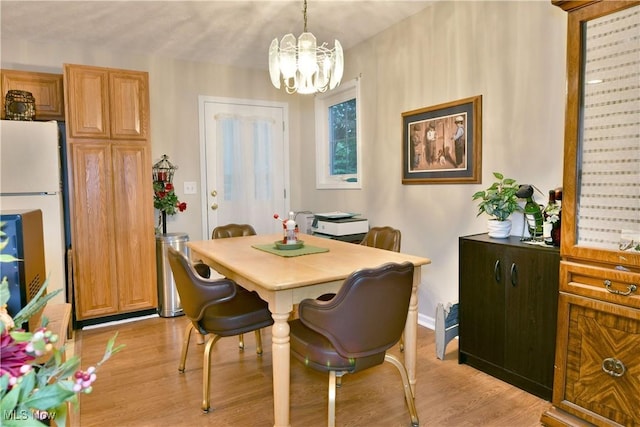 252 Greenbriar Dr, Cortland, OH 44410 - dining area featuring a chandelier and light wood-style flooring
