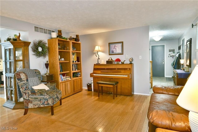 252 Greenbriar Dr, Cortland, OH 44410 - living area featuring wood finished floors and a textured ceiling