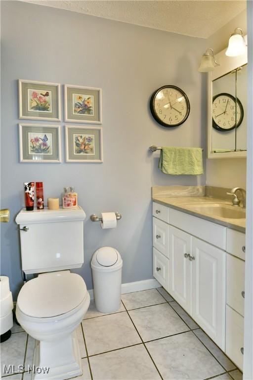 252 Greenbriar Dr, Cortland, OH 44410 - bathroom featuring vanity, tile patterned floors, and a textured ceiling