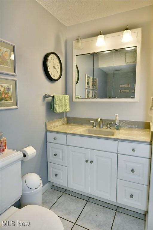 252 Greenbriar Dr, Cortland, OH 44410 - bathroom featuring vanity, tile patterned floors, and a textured ceiling