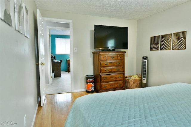 252 Greenbriar Dr, Cortland, OH 44410 - bedroom featuring wood finished floors and a textured ceiling