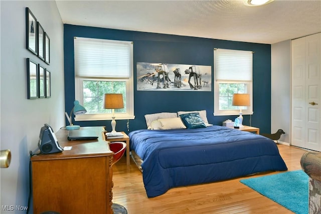 252 Greenbriar Dr, Cortland, OH 44410 - bedroom with wood finished floors and multiple windows