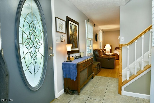 252 Greenbriar Dr, Cortland, OH 44410 - entrance foyer with light tile patterned floors and stairs