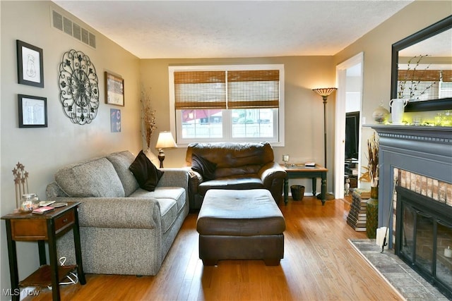 252 Greenbriar Dr, Cortland, OH 44410 - living area featuring a tiled fireplace and wood finished floors