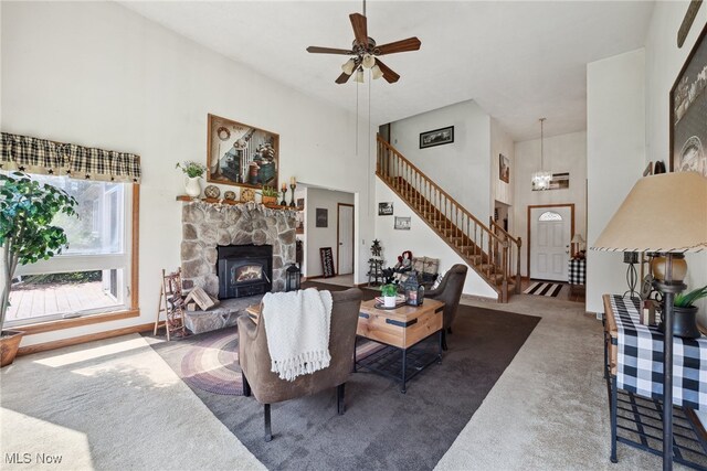3823 Kyle Rd, Dorset, OH 44032 - carpeted living room featuring stairway, a towering ceiling, ceiling fan, and a chandelier