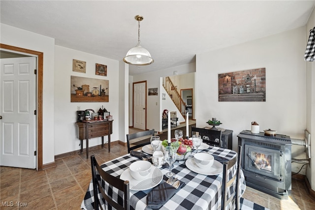 3823 Kyle Rd, Dorset, OH 44032 - dining space with stairs and a wood stove