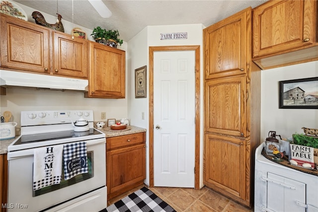 3823 Kyle Rd, Dorset, OH 44032 - kitchen featuring electric range, under cabinet range hood, light countertops, and brown cabinets