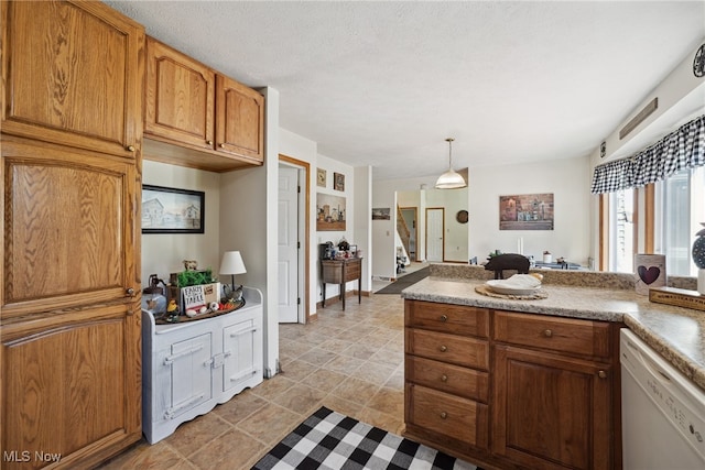 3823 Kyle Rd, Dorset, OH 44032 - kitchen with dishwasher, light countertops, brown cabinets, and decorative light fixtures