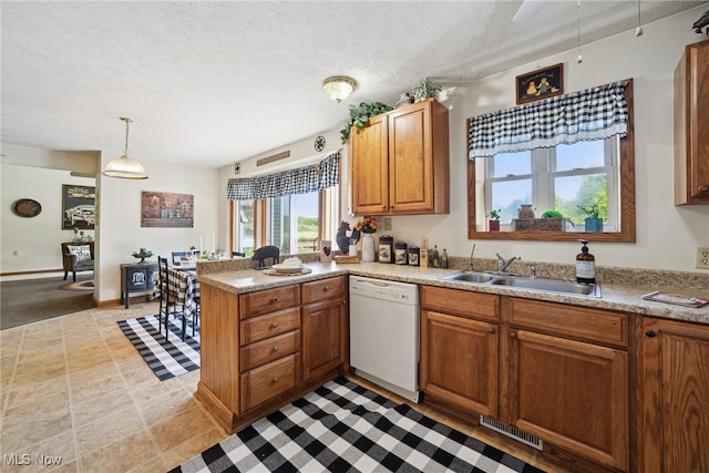 3823 Kyle Rd, Dorset, OH 44032 - kitchen with dishwasher, a peninsula, brown cabinets, a textured ceiling, and light countertops