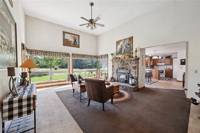 3823 Kyle Rd, Dorset, OH 44032 - living room with light carpet, a towering ceiling, ceiling fan, and a wood stove