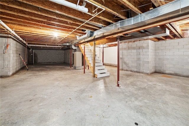 3823 Kyle Rd, Dorset, OH 44032 - unfinished below grade area with stairway, concrete block wall, and heating unit