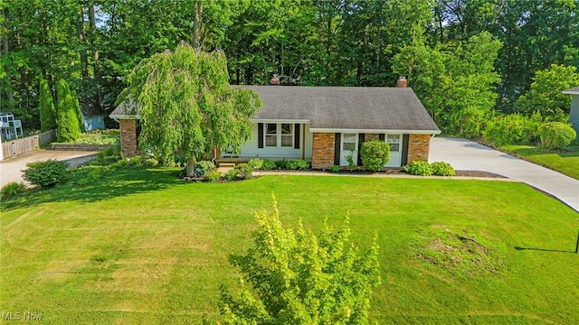 300 Chatham Dr, Aurora, OH 44202 - view of front of house featuring concrete driveway, a chimney, and brick siding