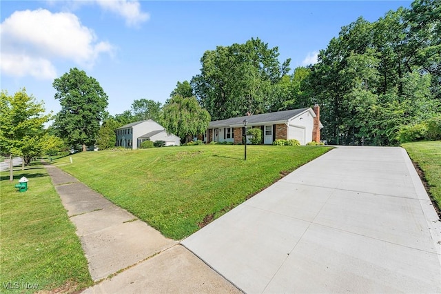 300 Chatham Dr, Aurora, OH 44202 - view of front of home with a front yard, driveway, an attached garage, and brick siding