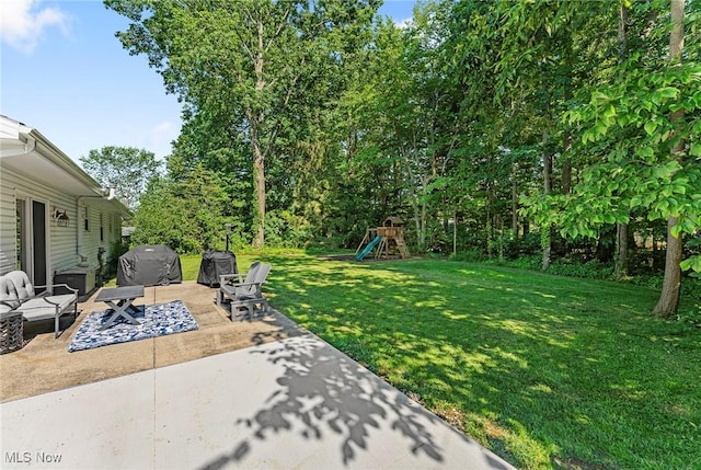 300 Chatham Dr, Aurora, OH 44202 - view of green lawn featuring a patio and a playground