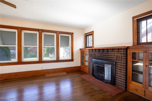 289-2891/2 E Baird Ave, Barberton, OH 44203 - unfurnished living room with dark wood-type flooring and a tiled fireplace