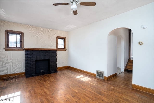 289-2891/2 E Baird Ave, Barberton, OH 44203 - unfurnished living room with wood-type flooring, ceiling fan, and healthy amount of natural light