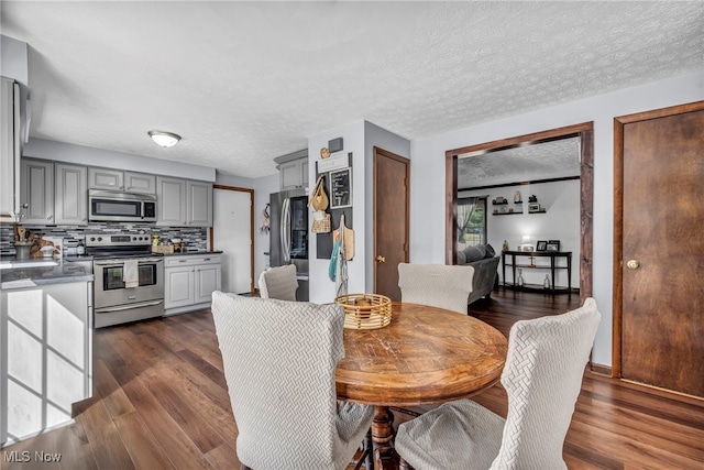9827 Akron Rd, Rittman, OH 44270 - dining space featuring dark wood-style flooring and a textured ceiling