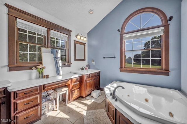 9827 Akron Rd, Rittman, OH 44270 - full bath with vaulted ceiling, vanity, a whirlpool tub, tile patterned floors, and a textured ceiling