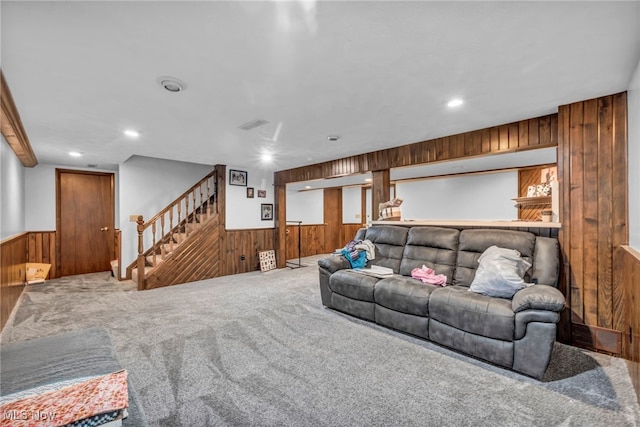 9827 Akron Rd, Rittman, OH 44270 - carpeted living area featuring wooden walls, wainscoting, stairway, and recessed lighting