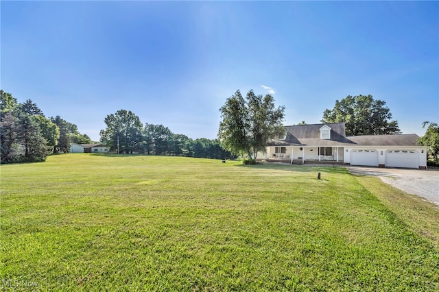 9827 Akron Rd, Rittman, OH 44270 - view of grassy yard featuring a garage and driveway