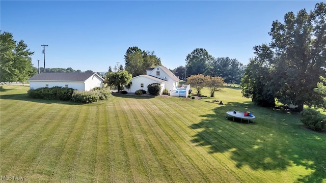 9827 Akron Rd, Rittman, OH 44270 - view of green lawn featuring a trampoline