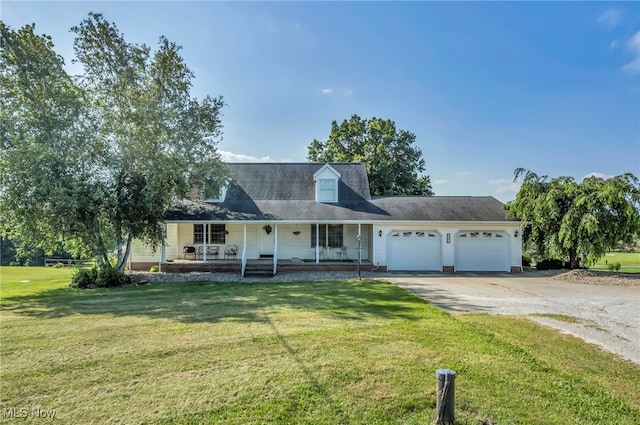 9827 Akron Rd, Rittman, OH 44270 - view of front of home featuring driveway, a garage, covered porch, and a front yard