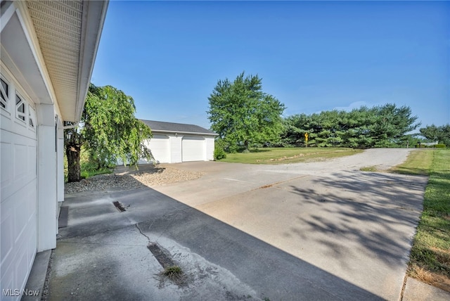 9827 Akron Rd, Rittman, OH 44270 - view of patio with a garage and an outbuilding