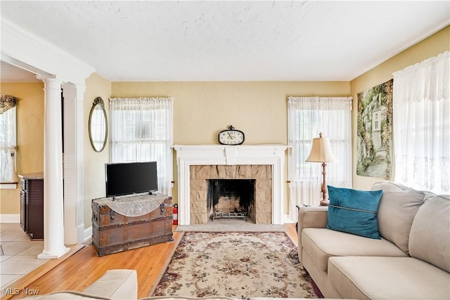 6100 Glenwood Ave, Boardman, OH 44512 - living area featuring decorative columns, healthy amount of natural light, light wood-style flooring, and a fireplace