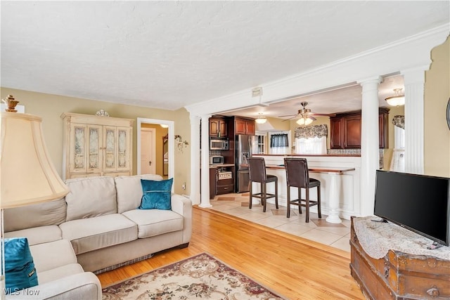 6100 Glenwood Ave, Boardman, OH 44512 - living room with light wood-type flooring, a ceiling fan, and decorative columns