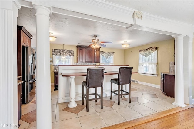 6100 Glenwood Ave, Boardman, OH 44512 - kitchen featuring stainless steel fridge, decorative columns, a kitchen breakfast bar, a ceiling fan, and crown molding