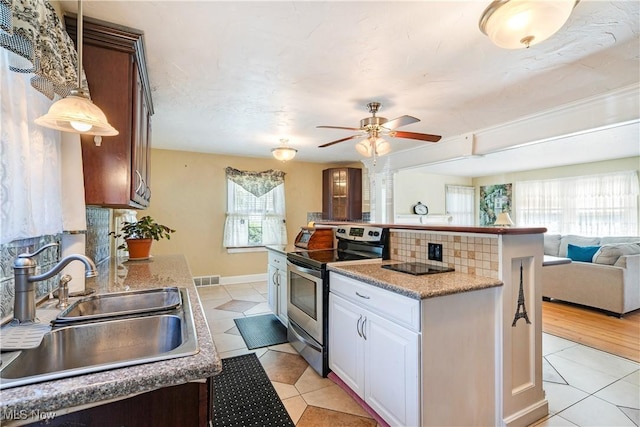 6100 Glenwood Ave, Boardman, OH 44512 - kitchen with electric range, open floor plan, a kitchen island, a ceiling fan, and light tile patterned floors