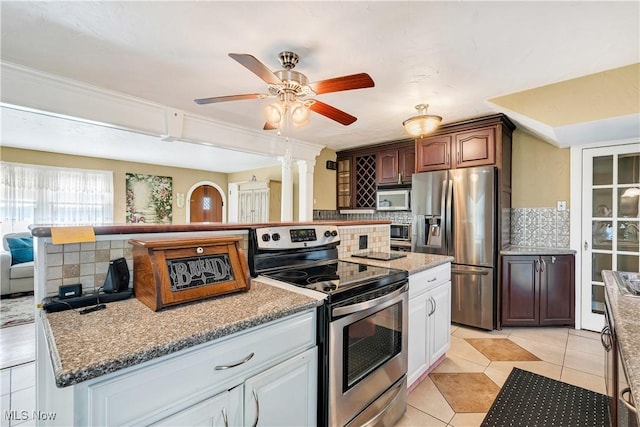 6100 Glenwood Ave, Boardman, OH 44512 - kitchen with appliances with stainless steel finishes, backsplash, ceiling fan, light tile patterned flooring, and decorative columns