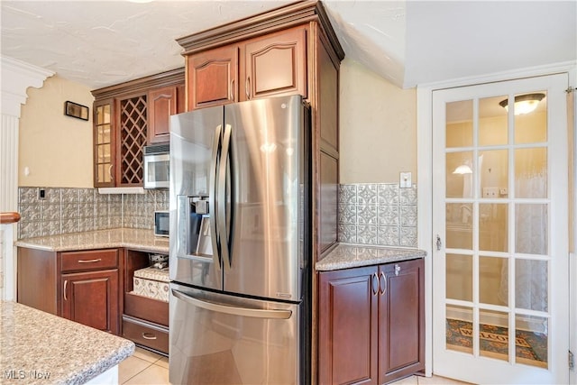 6100 Glenwood Ave, Boardman, OH 44512 - kitchen featuring stainless steel refrigerator with ice dispenser, tasteful backsplash, light tile patterned floors, and light stone countertops