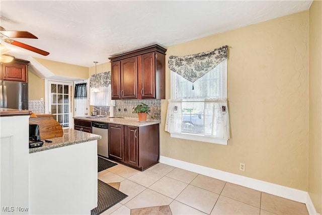 6100 Glenwood Ave, Boardman, OH 44512 - kitchen featuring stainless steel appliances, ceiling fan, tasteful backsplash, light tile patterned flooring, and decorative light fixtures