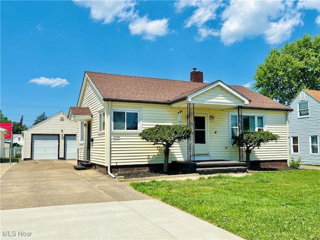 3109 Latimer Ave, Ashtabula, OH 44004 - view of front of property featuring an outbuilding, a chimney, a front yard, a shingled roof, and a garage