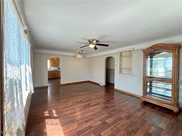 3109 Latimer Ave, Ashtabula, OH 44004 - unfurnished living room featuring arched walkways, ceiling fan, and dark wood-style flooring