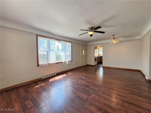3109 Latimer Ave, Ashtabula, OH 44004 - empty room with arched walkways, ceiling fan, and dark wood-style flooring