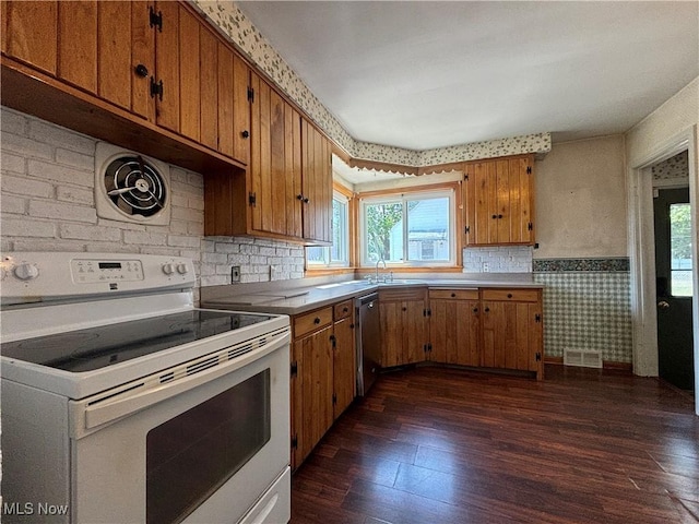 3109 Latimer Ave, Ashtabula, OH 44004 - kitchen with white electric range, brown cabinetry, dark wood-style flooring, wainscoting, and dishwasher