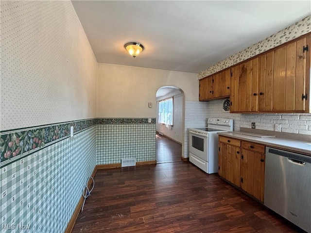 3109 Latimer Ave, Ashtabula, OH 44004 - kitchen with electric range, dishwasher, wallpapered walls, arched walkways, and dark wood finished floors
