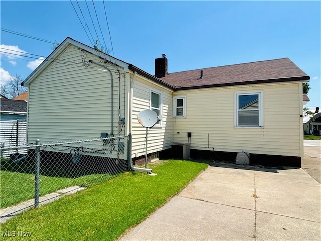 3109 Latimer Ave, Ashtabula, OH 44004 - rear view of house featuring a chimney, a patio area, and roof with shingles