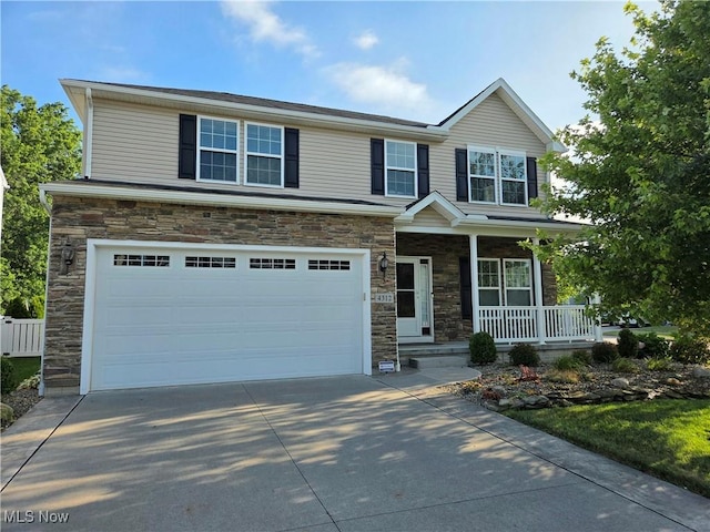 4312 Brooks Ct, Lorain, OH 44053 - view of front of home with stone siding, a porch, and an attached garage
