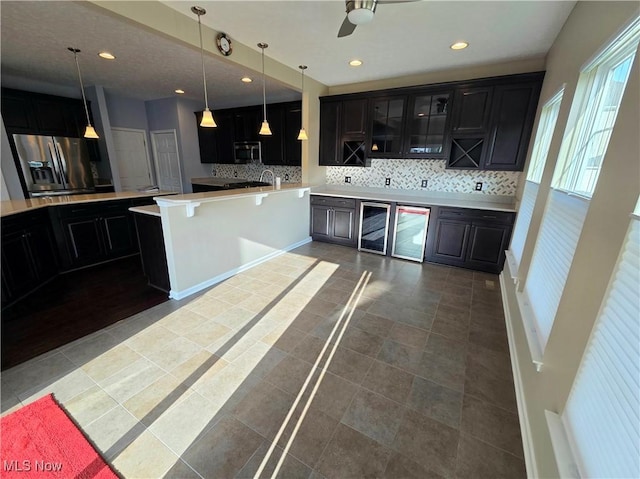 4312 Brooks Ct, Lorain, OH 44053 - kitchen featuring stainless steel appliances, backsplash, a peninsula, glass insert cabinets, and recessed lighting
