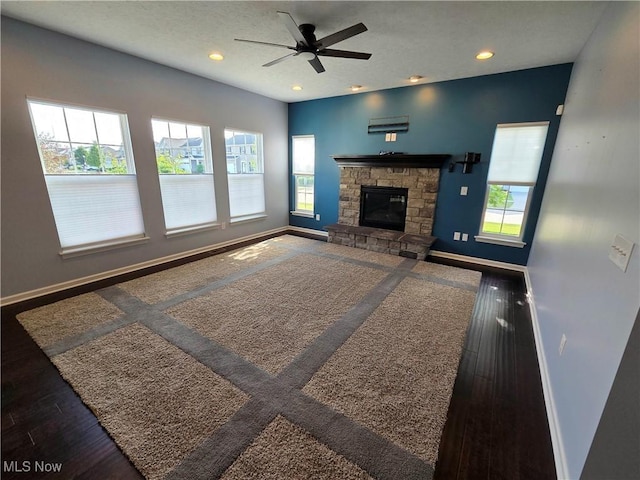 4312 Brooks Ct, Lorain, OH 44053 - unfurnished living room featuring ceiling fan, a stone fireplace, recessed lighting, and wood finished floors