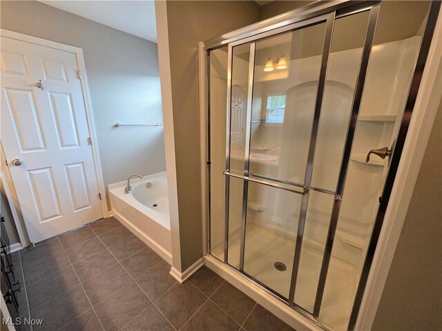 4312 Brooks Ct, Lorain, OH 44053 - bathroom with a tub with jets, tile patterned floors, and a shower stall