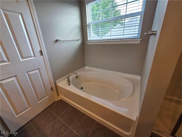 4312 Brooks Ct, Lorain, OH 44053 - bathroom with a garden tub and tile patterned floors