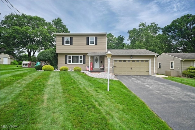48 Mary Ann Ln, Youngstown, OH 44511 - view of front facade featuring driveway, a garage, and a front yard