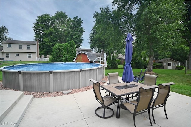 48 Mary Ann Ln, Youngstown, OH 44511 - swimming pool featuring outdoor dining area, a yard, a patio area, and a shed
