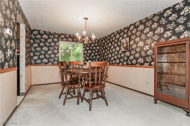 751 Bacon Rd, Oh, OH 44077 - dining room featuring wallpapered walls, a chandelier, and carpet flooring